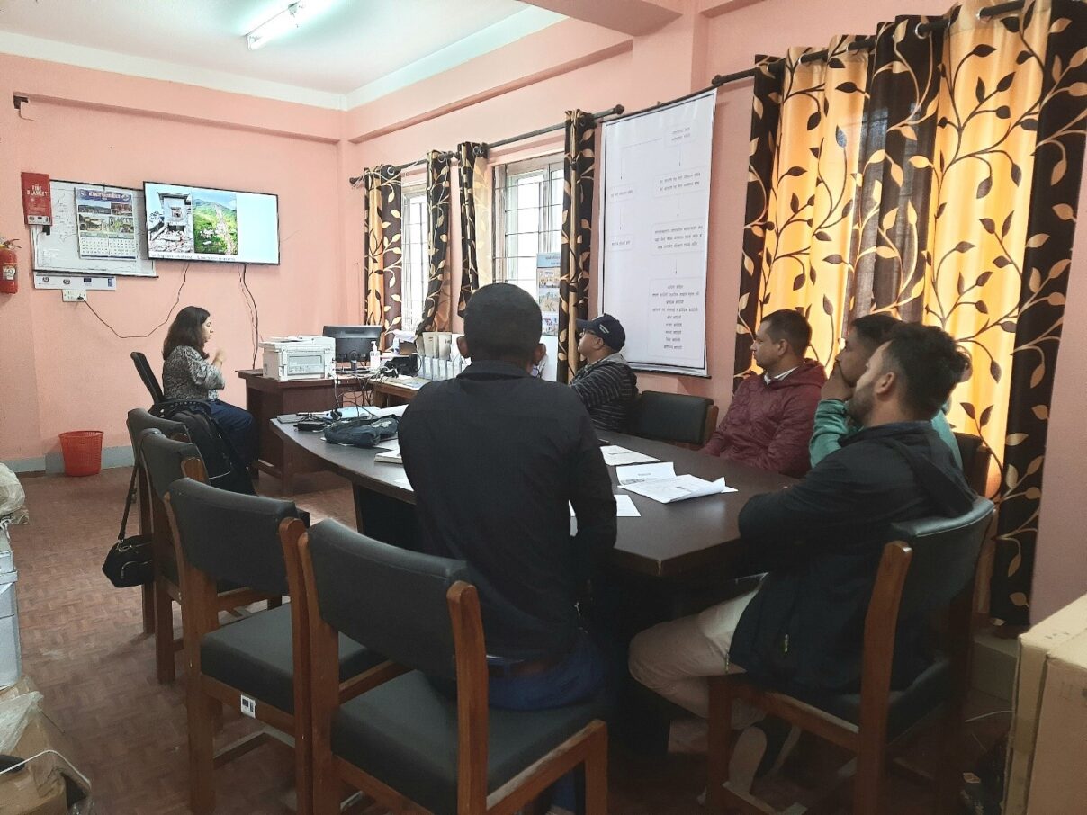 Sweata presenting Sajag-Nepal and linking the slope monitoring equipment inside the MEOC office, along with technical team from Bhimeshwor Municipality